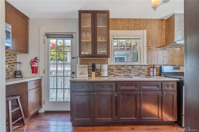 a kitchen with a sink cabinets and window