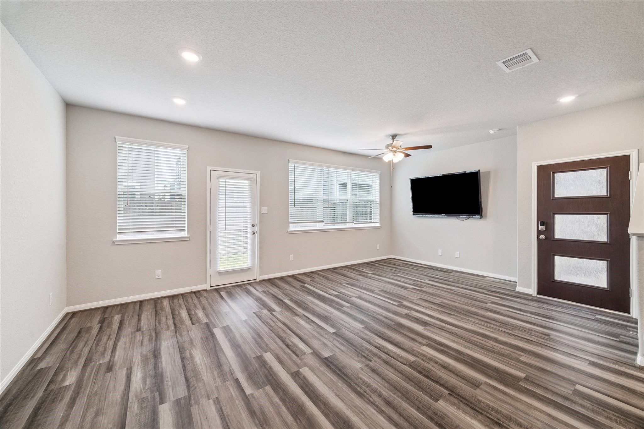 5502 Cuerta Street Houston, TX 77023 - Photo 5 of 25 Bright and airy! You will love spending time in this modern family room with its luxury vinyl plan flooring.