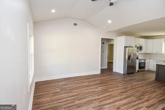 a view of a hallway with wooden floor