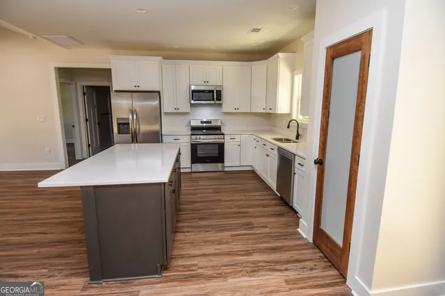 a bathroom with a sink a toilet a shower and a mirror