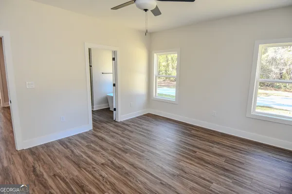 a view of an entryway with wooden floor