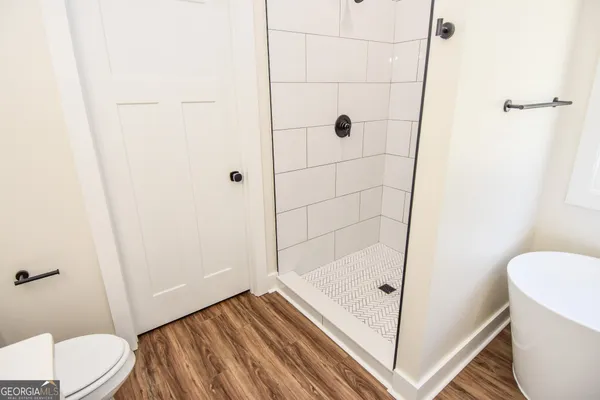 a bathroom with a sink a toilet and a mirror