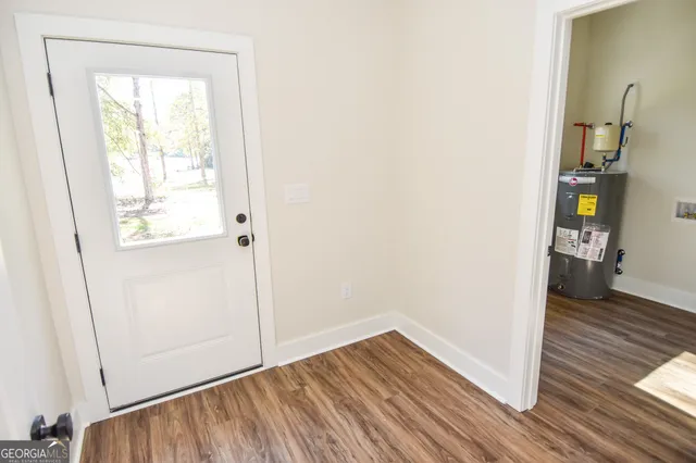a backyard of a house with large trees and outdoor space