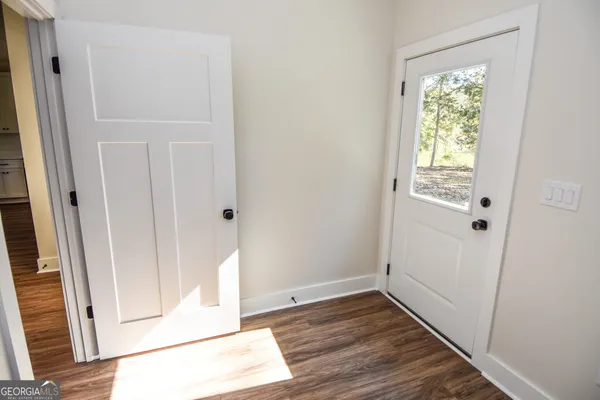 an aerial view of residential house with outdoor space and trees all around