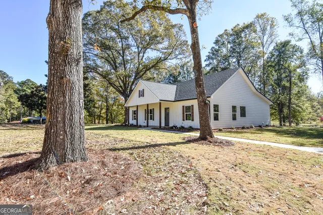 a view of a kitchen with a sink refrigerator and wooden floor