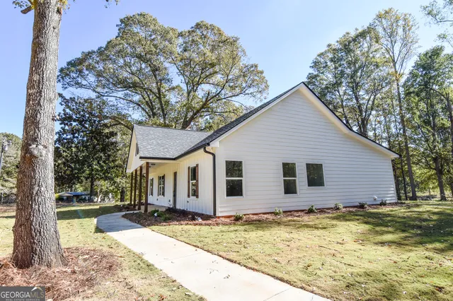 a view of a kitchen with a fridge and wooden floor