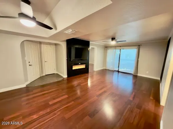 a view of empty room with wooden floor