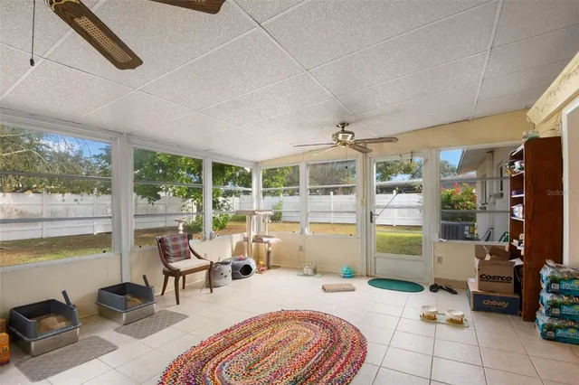 a bedroom with furniture and large windows