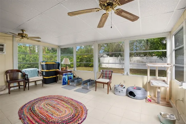 a living room with furniture and a floor to ceiling window