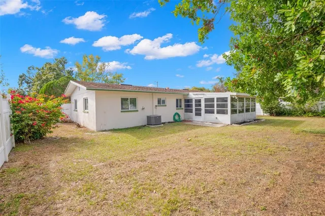 a view of a house with a backyard
