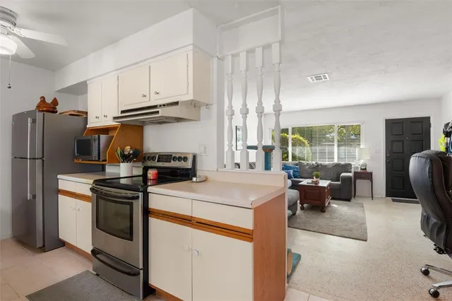 a kitchen that has a refrigerator and a stove