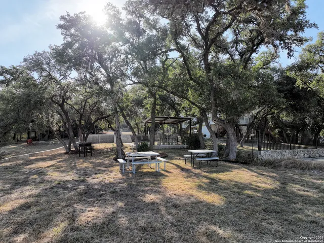 a backyard of a house with table and chairs