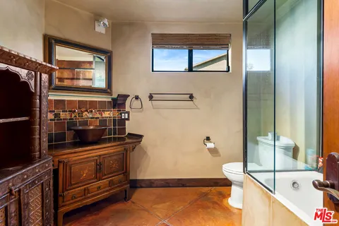 a bathroom with a tub and a sink