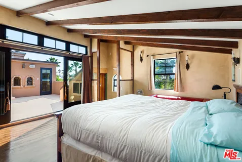 a bedroom with a large bed and a large window