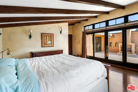 a bedroom with a large bed and a large window