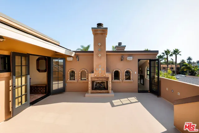 a view of a patio with a fireplace and furniture