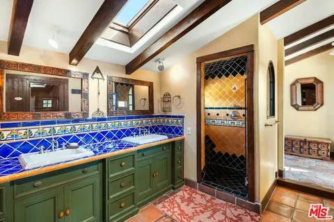 a view of a hallway with wooden floor and furniture