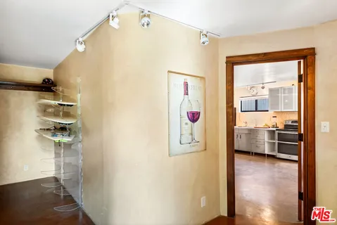 a large kitchen with a large window and stainless steel appliances
