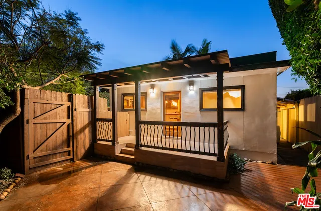 a view of a deck with a table and chairs with wooden fence