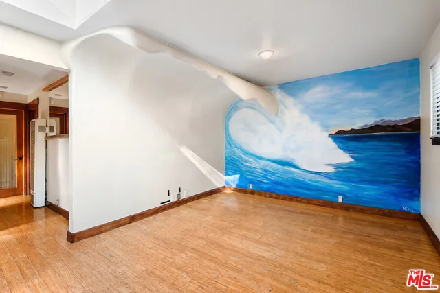 a view of a kitchen with a sink a microwave and cabinets