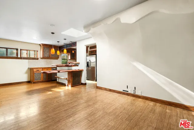a view of a room with wooden floor and window