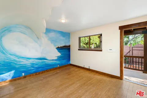 a view of a kitchen with furniture and wooden floor