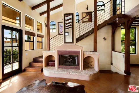 a view of living room with furniture and a fireplace