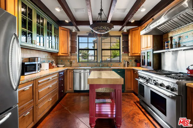 a kitchen with stainless steel appliances granite countertop a stove and a refrigerator