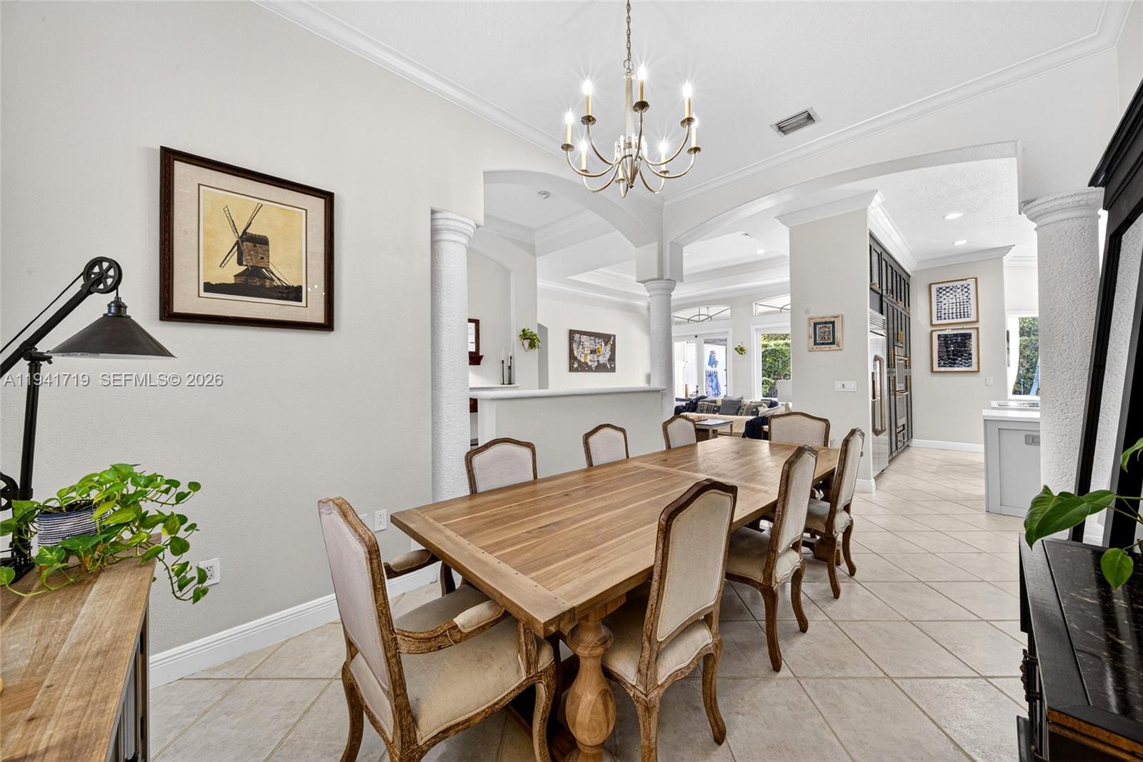 12530 Southwest 96th Court Miami, FL 33176 - Photo 14 of 82 a view of a dining room with furniture and a chandelier