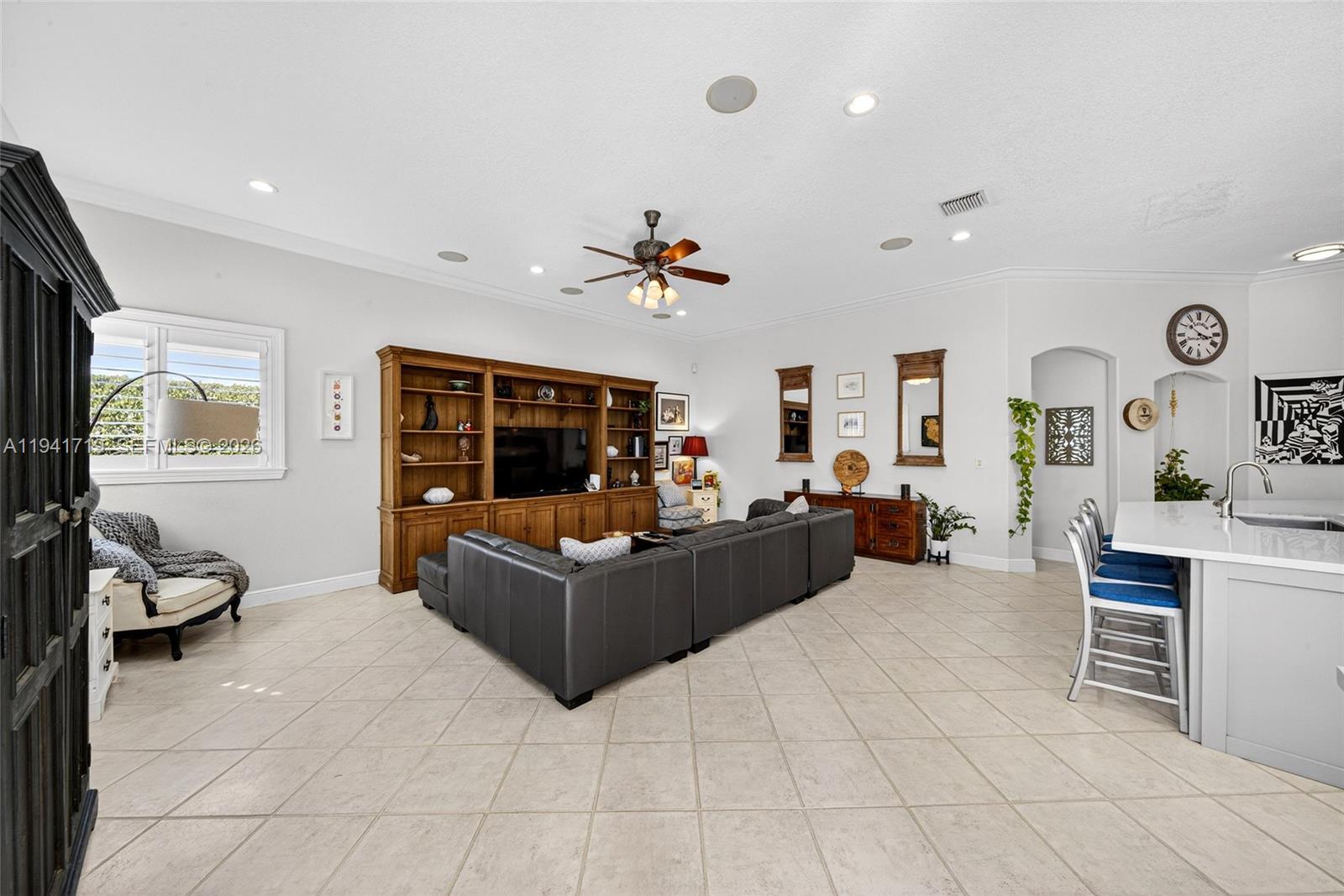 12530 Southwest 96th Court Miami, FL 33176 - Photo 29 of 82 a living room with furniture a flat screen tv and a large window