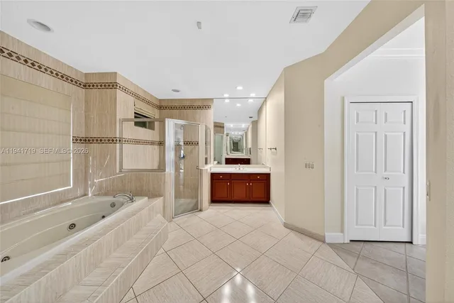 a living room with furniture fireplace and a large window