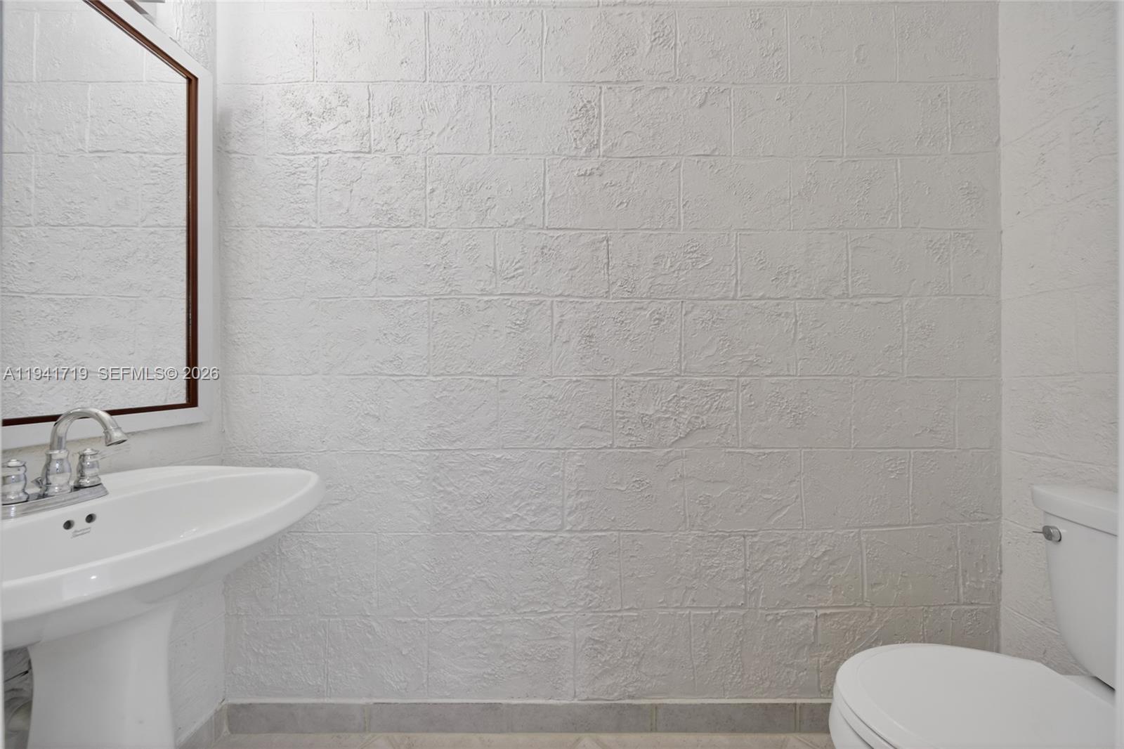 12530 Southwest 96th Court Miami, FL 33176 - Photo 52 of 82 a bathroom with a toilet a sink and mirror