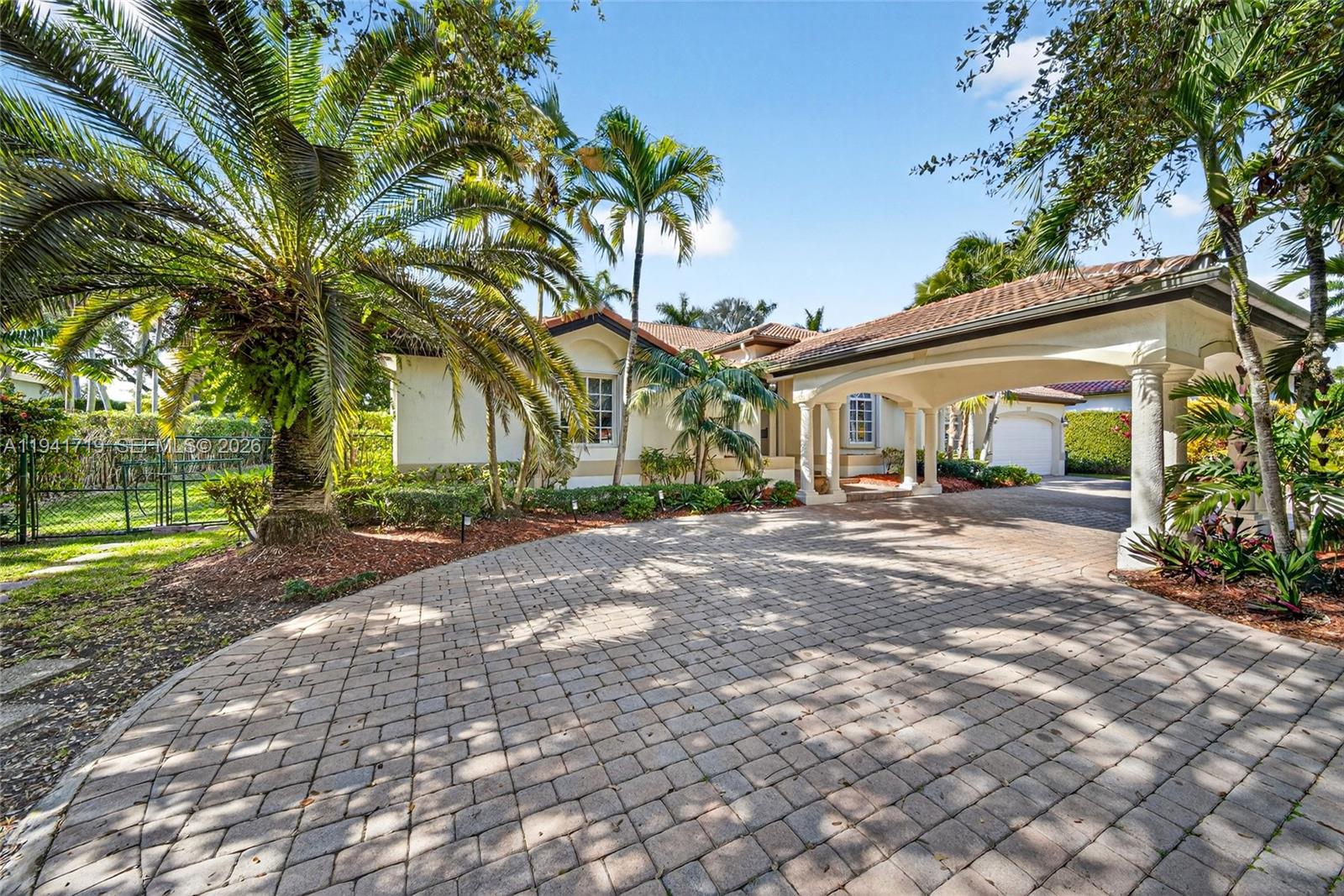 12530 Southwest 96th Court Miami, FL 33176 - Photo 6 of 82 a front view of a house with a yard and potted plants