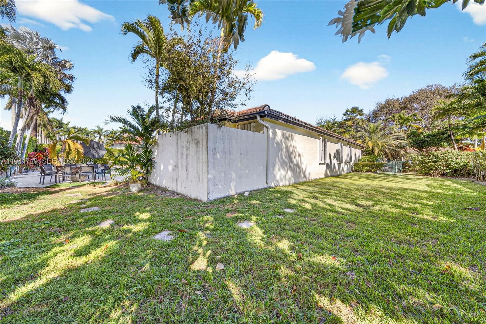 12530 Southwest 96th Court Miami, FL 33176 - Photo 74 of 82 a view of a yard with an tree and a wooden fence