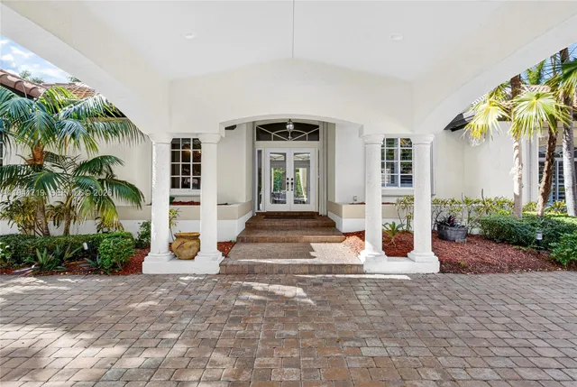 a view of a dining room with furniture and a chandelier