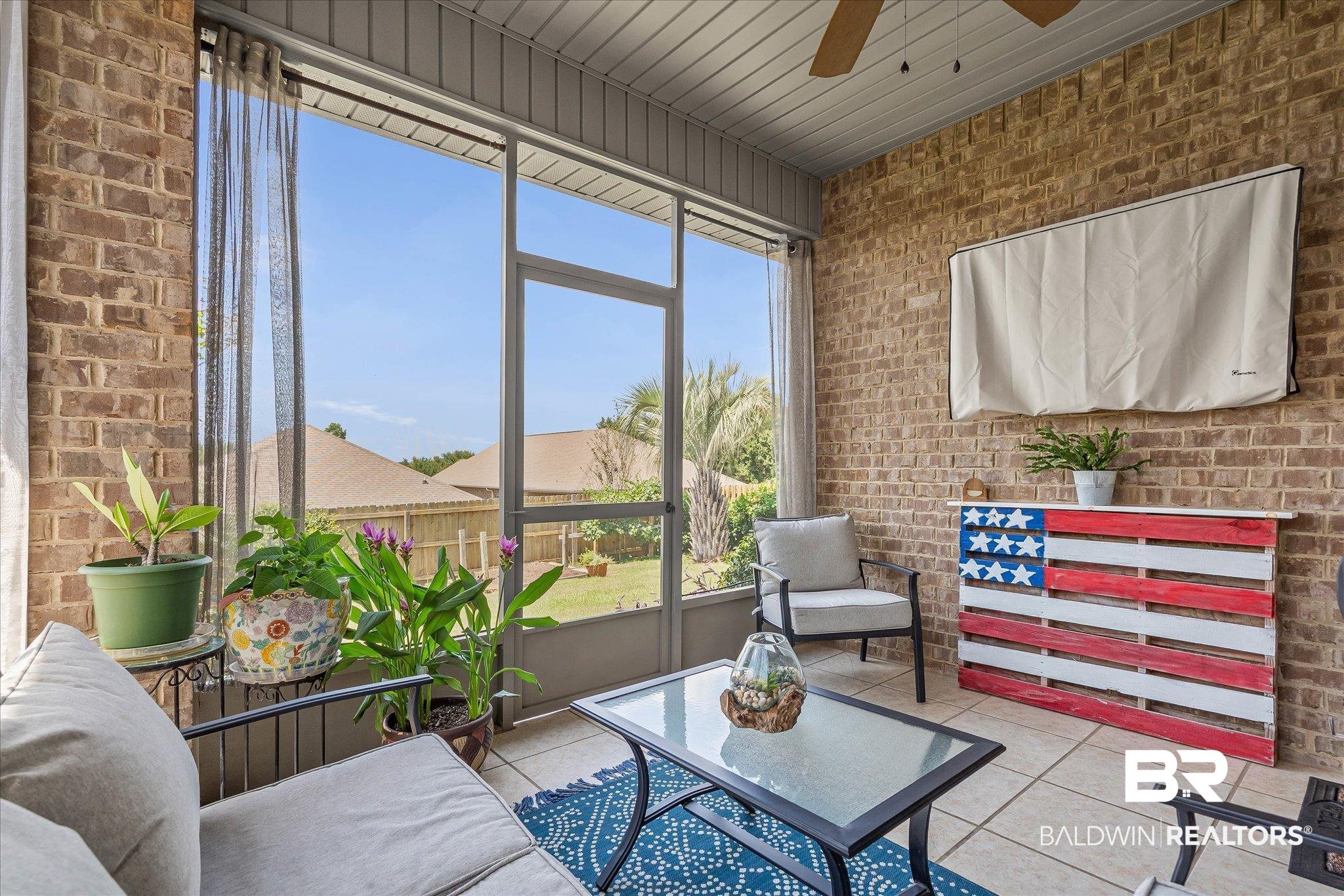 10677 Orkney Way Spanish Fort, AL 36527 - Photo 16 of 22 Sunroom / solarium with brick wall, ceiling fan, and tile patterned floors