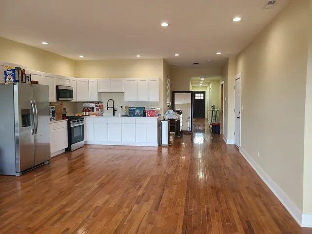 a view of a hallway to a livingroom and furniture