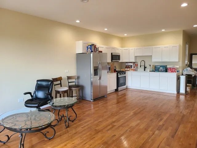 a view of kitchen with cabinets table and chairs