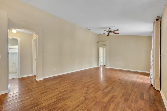 a view of empty room with wooden floor