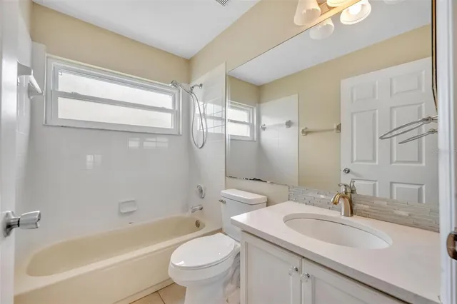 an empty room with a ceiling fan and a window