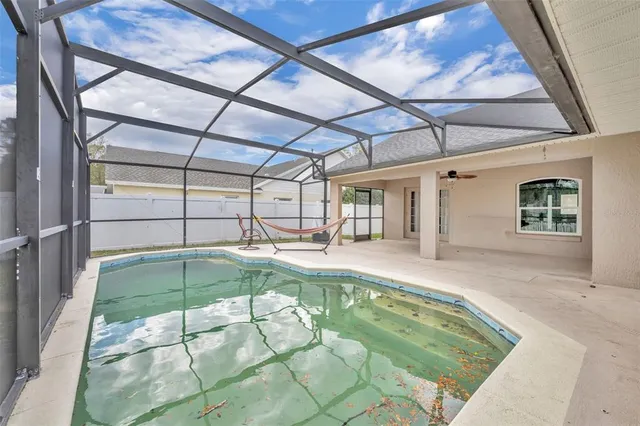 a swimming pool with table and chairs