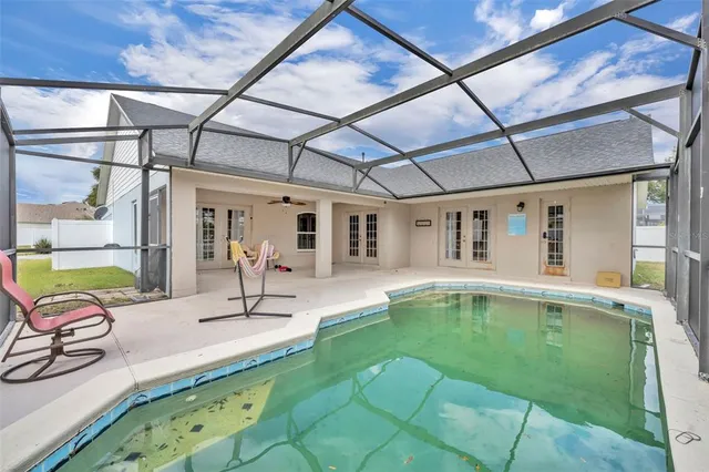 a view of yard with large trees and fence