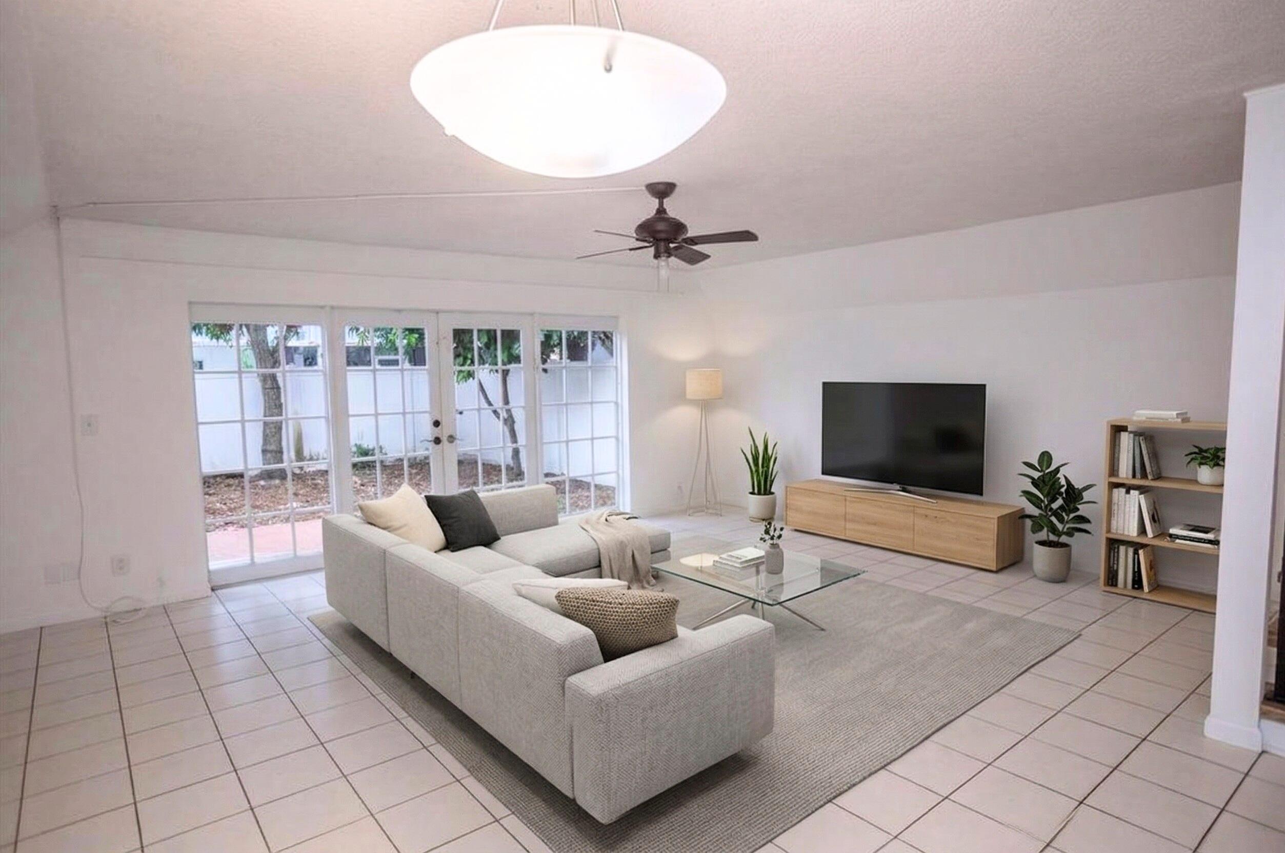 6764 Southwest 40th Street, Unit 40 Davie, FL 33314 - Photo 1 of 17 a living room with furniture and a flat screen tv