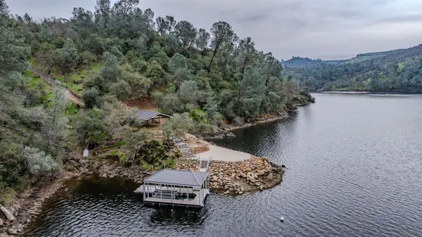 an aerial view of a house with a yard basket ball court and outdoor seating