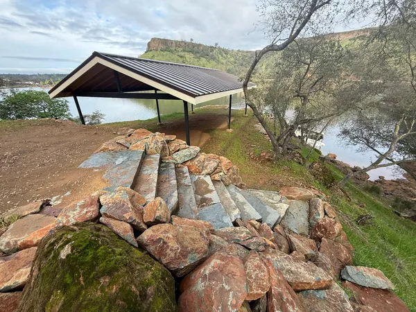 a wooden bench sitting in front of a house