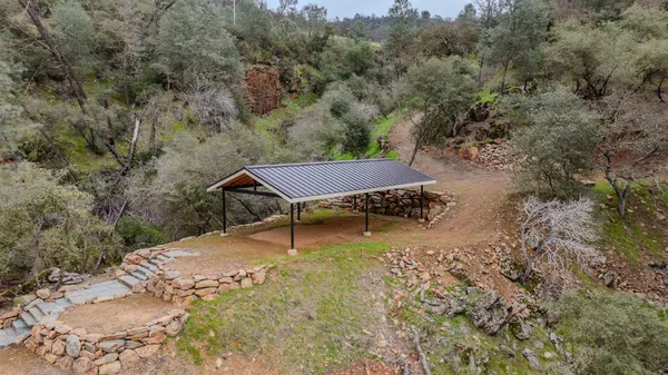 an aerial view of residential houses with outdoor space and trees