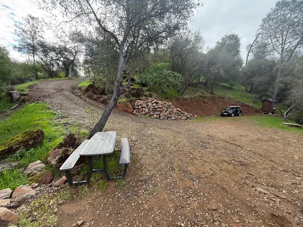 a backyard of a house with table and chairs