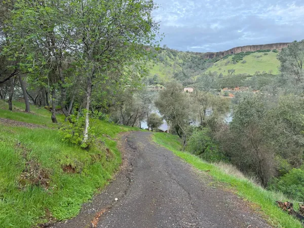 an aerial view of a houses with a lake view