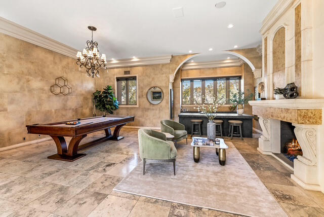 20 Vía Condotti Rancho Mirage, CA 92270 - Photo 17 of 40 a living room with furniture a fireplace and a chandelier