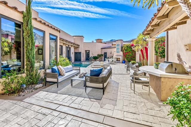 20 Vía Condotti Rancho Mirage, CA 92270 - Photo 2 of 40 a view of a patio with couches table and chairs and potted plants